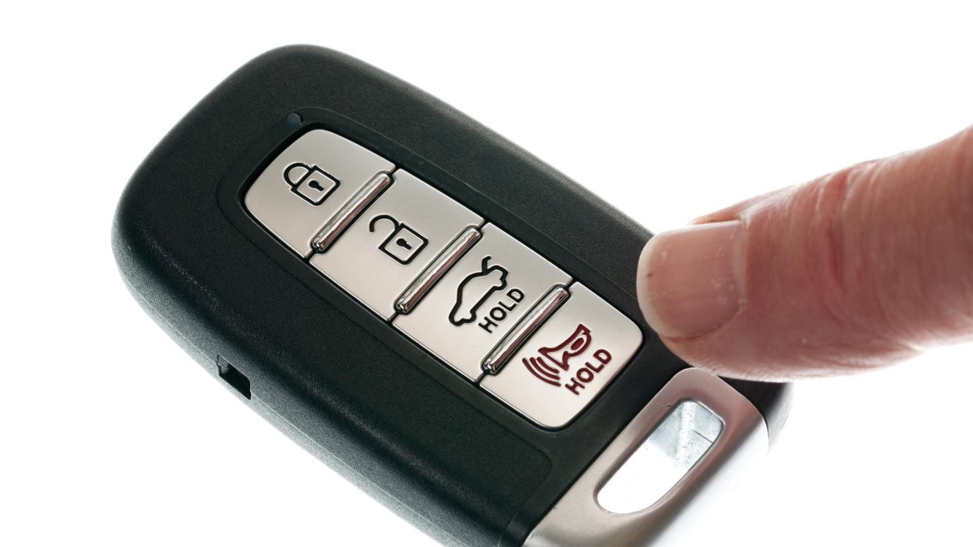 Close-up of a car key being inserted into the ignition to program the remote starter.