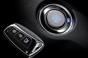 Close-up of a Hyundai key fob and car ignition, illustrating keyless entry system components for Hyundai car remote programming guidance.