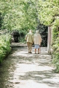 Smiling elderly couple sitting together, representing family caregiving