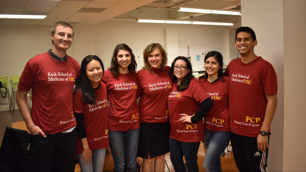 Alumni students pictured in their Primary Care Program shirts and with Primary Care Program Director, Dr. Jo Marie Reilly