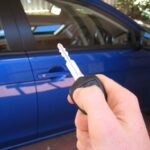 Car key fob transmitting radio wave signals for remote locking and unlocking.