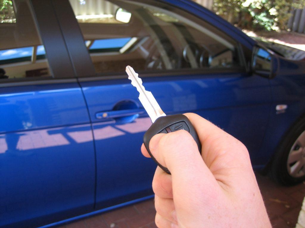 Car key fob transmitting radio wave signals for remote locking and unlocking.