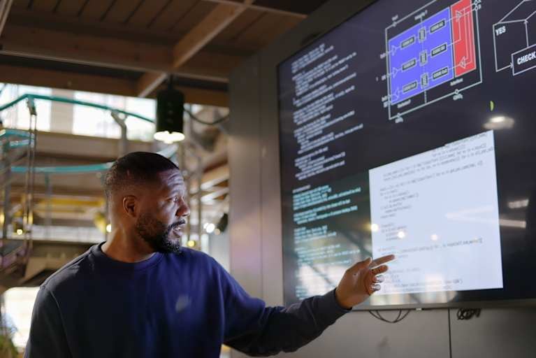 Person collaborating on a computer, representing technology and STEM careers.